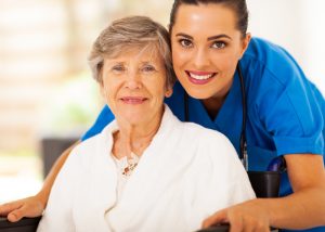 caregiver and older woman smiling